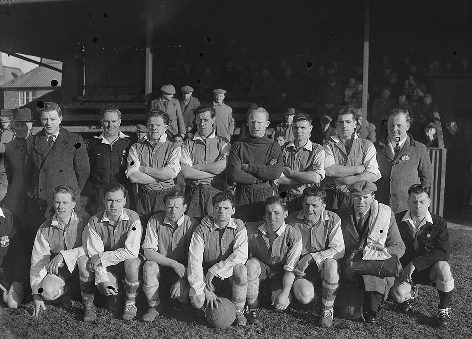 Hinchas siguiendo un partido internacional en un bar deportivo